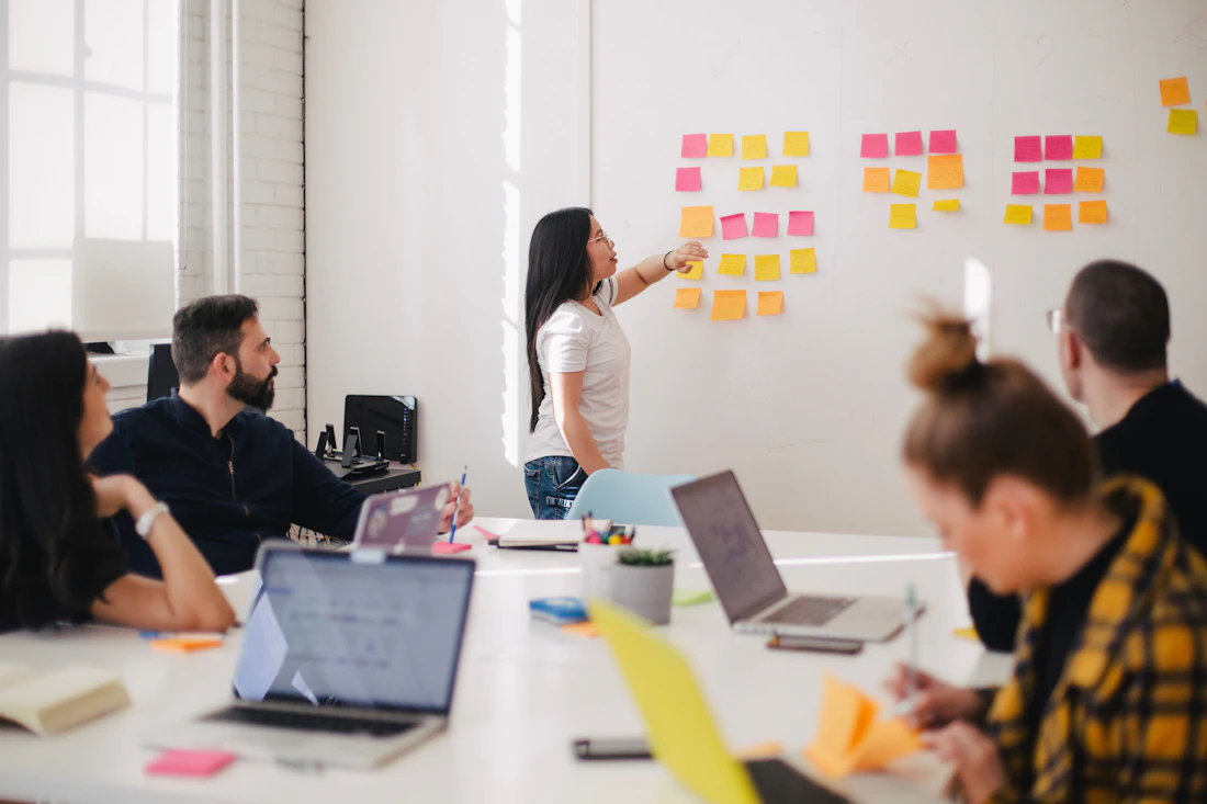 Business team discussing a plan in a naturally lit meeting room
